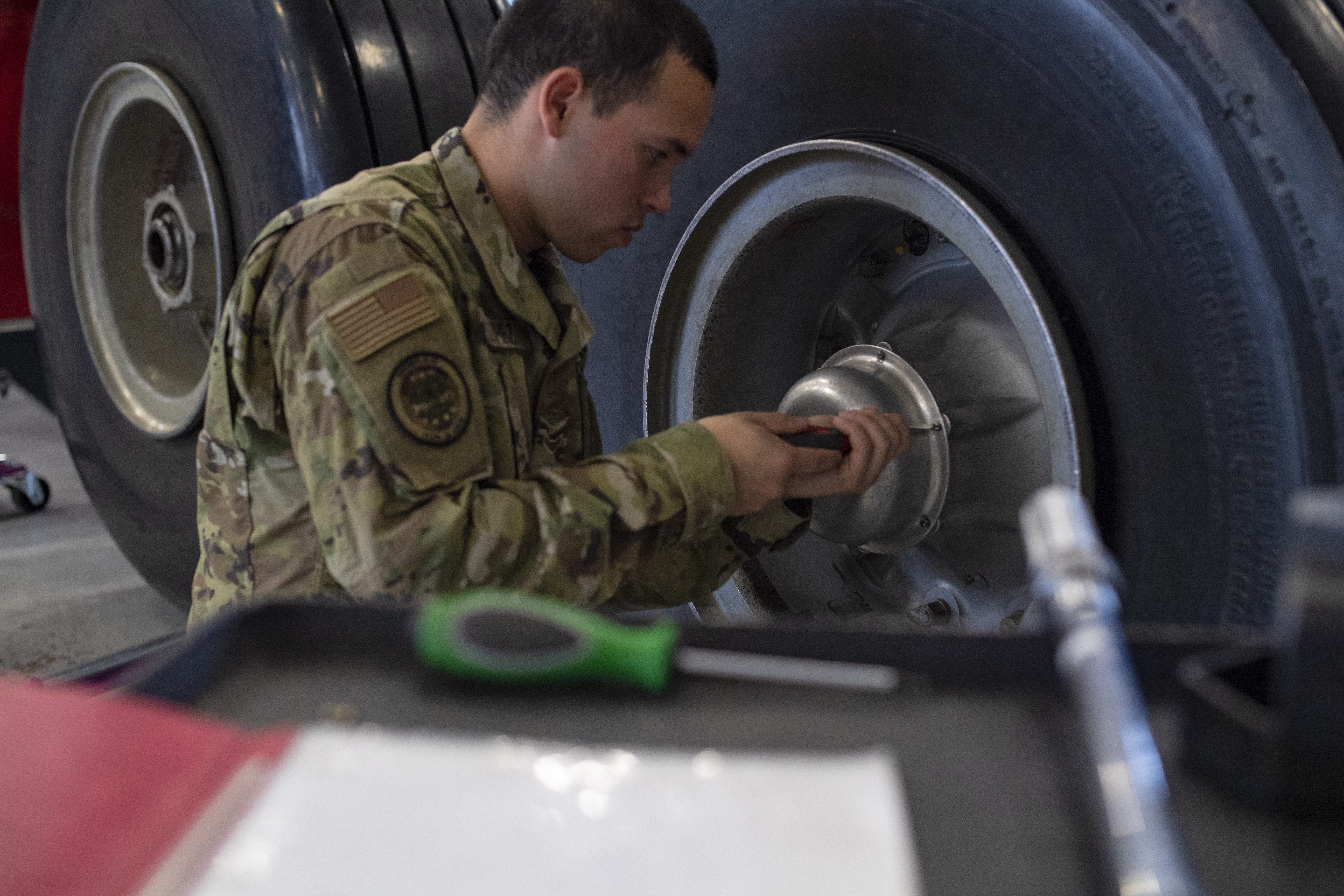 Student removing a tire from a wheel assembly